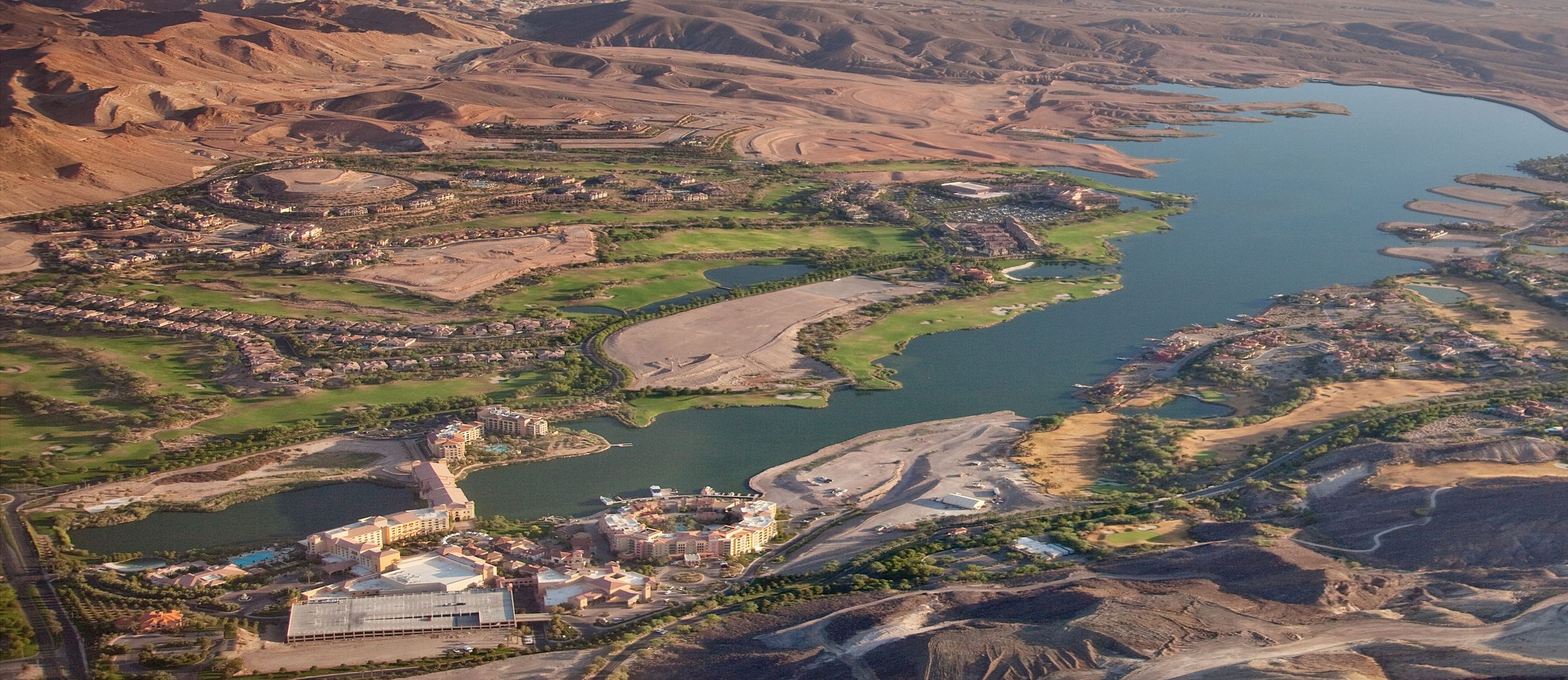 Aerial view of Lake Las Vegas, showing the lake, Mediterranean-style homes, and desert mountains
